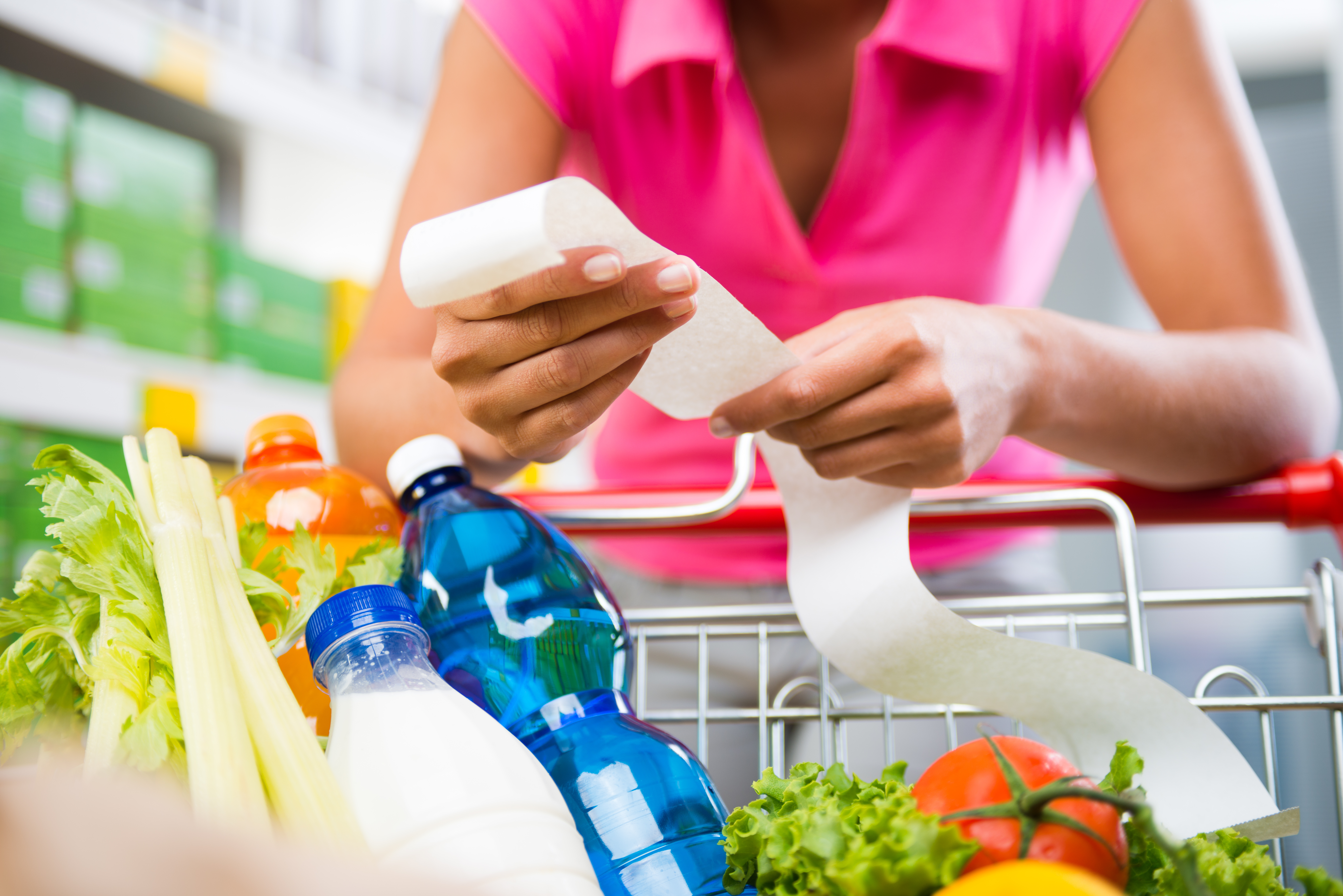 woman looking at a grocery receipt